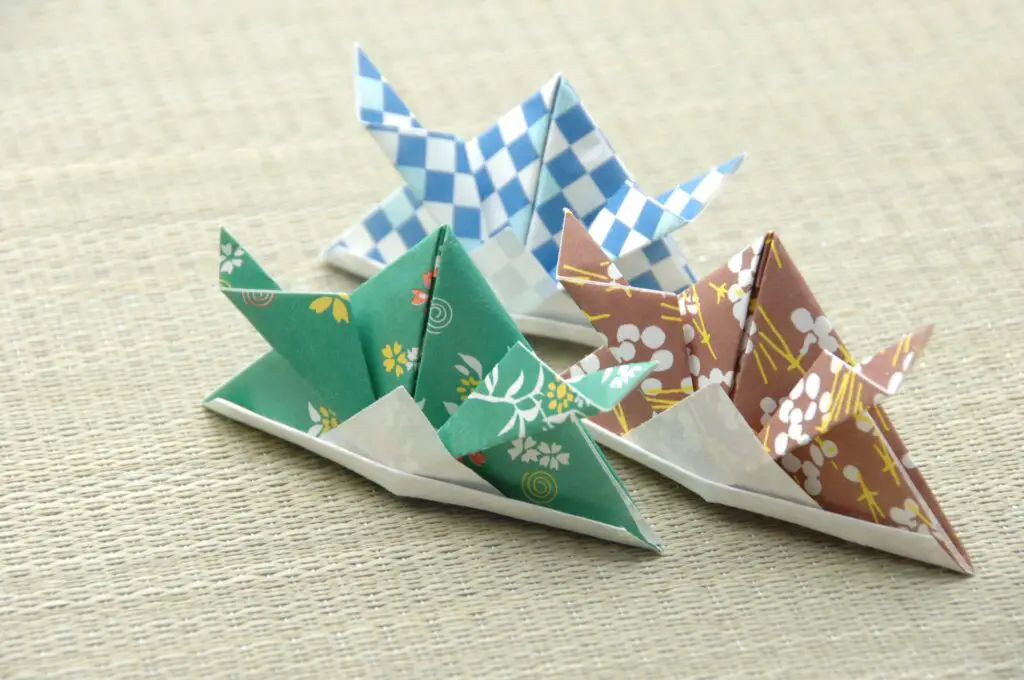 Three paper miniature Kabuto helmets